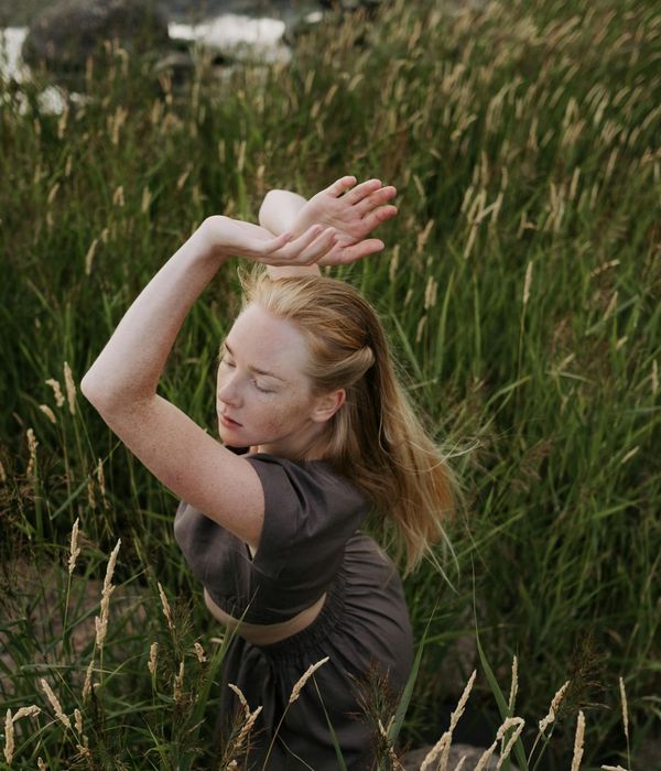 Person performing a graceful balancing exercise in a calm environment.
